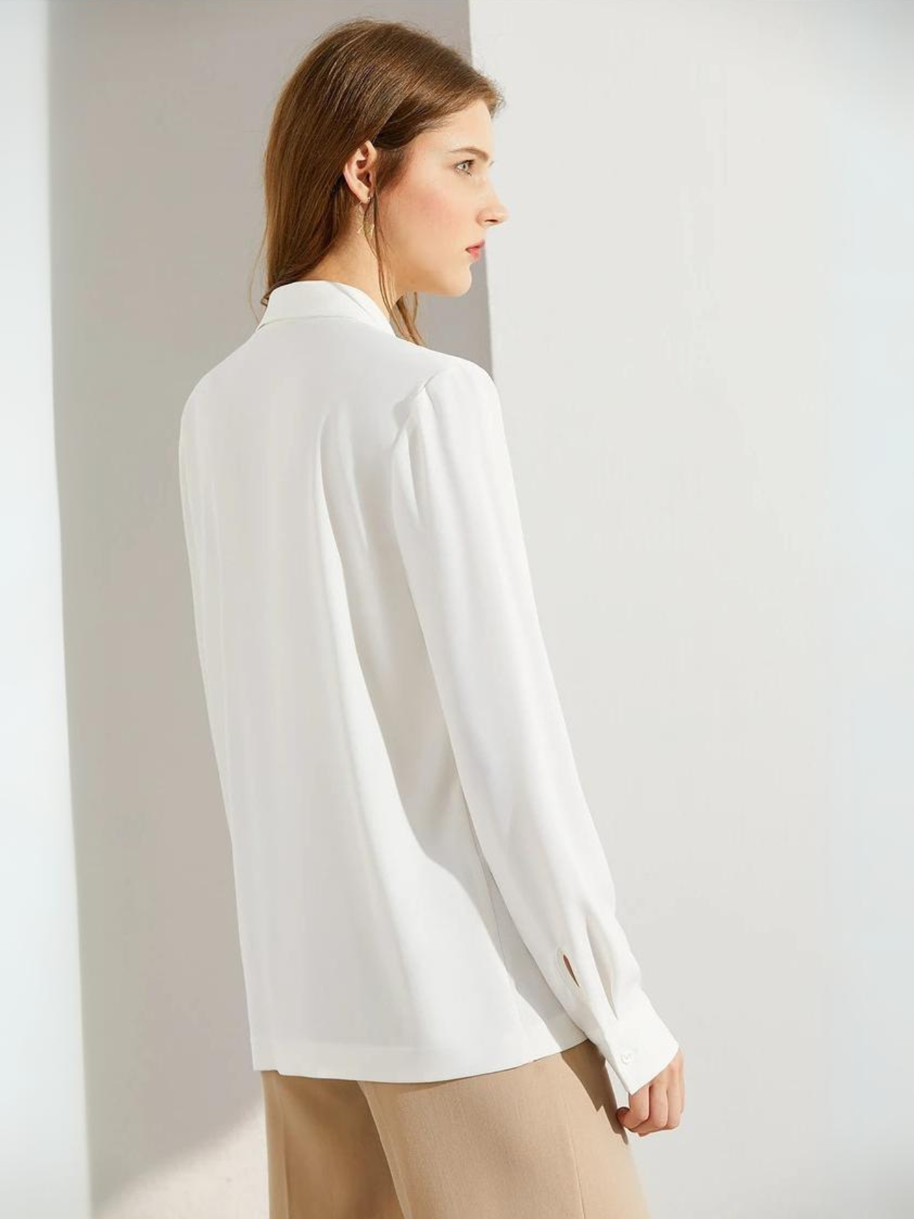 Woman turned slightly away, showing blouse back and side