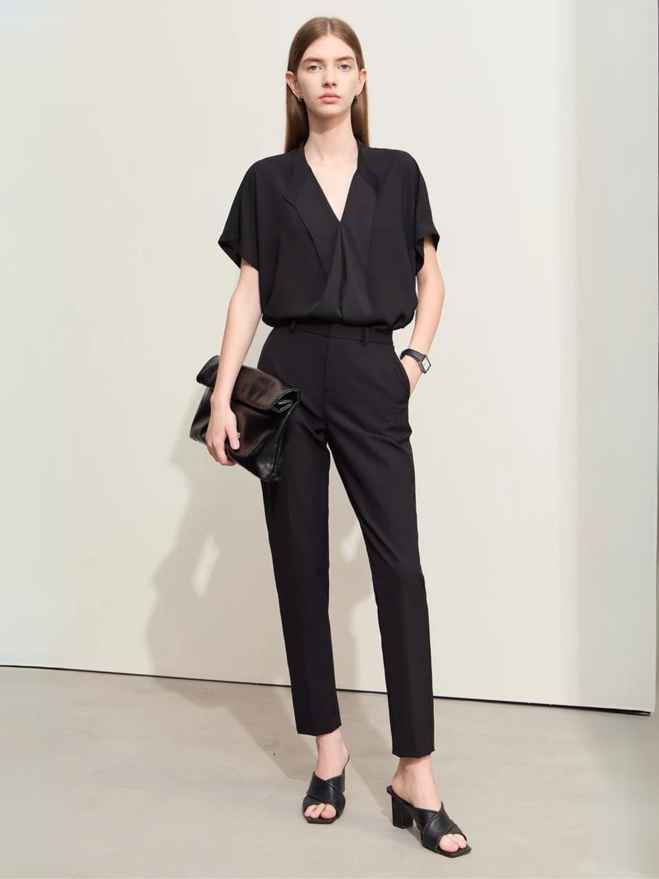 Back view of black blouse with loose fit