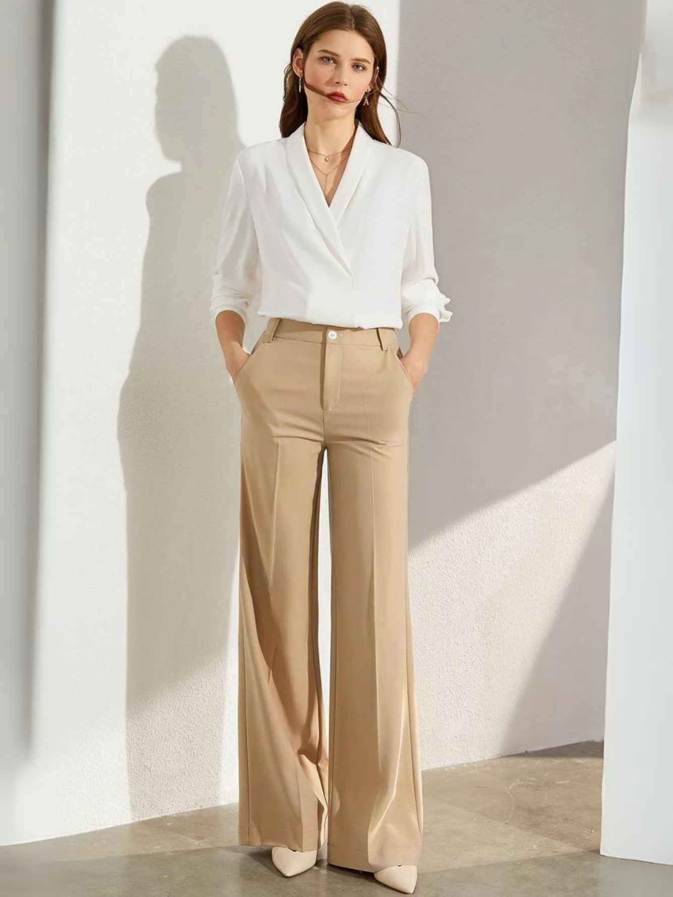 Full-body view of model in white blouse and wide-leg pants