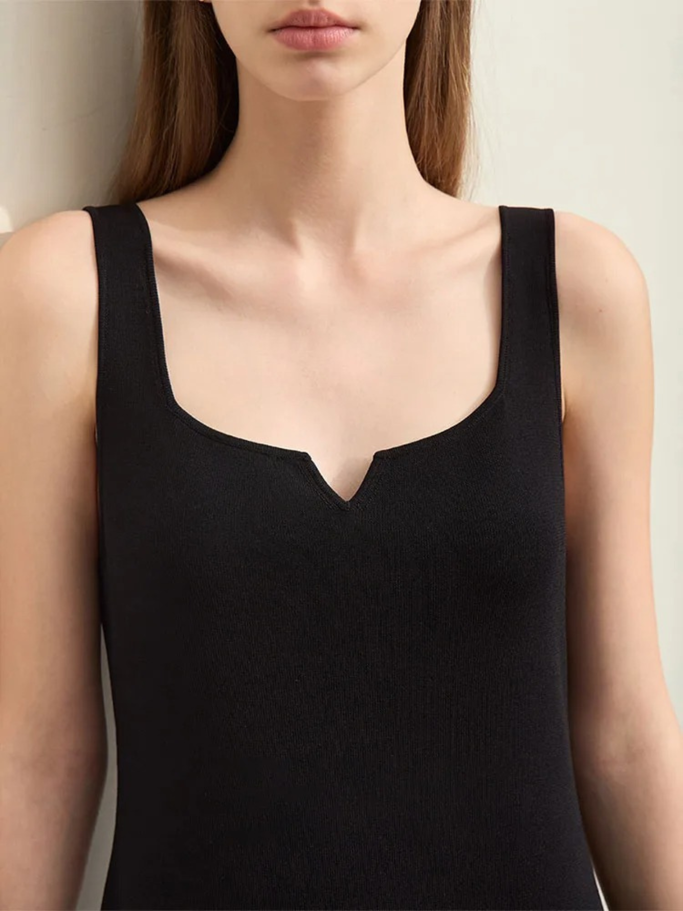 A close up of the dress focusing on the thin straps and the small cut out design on the neckline.