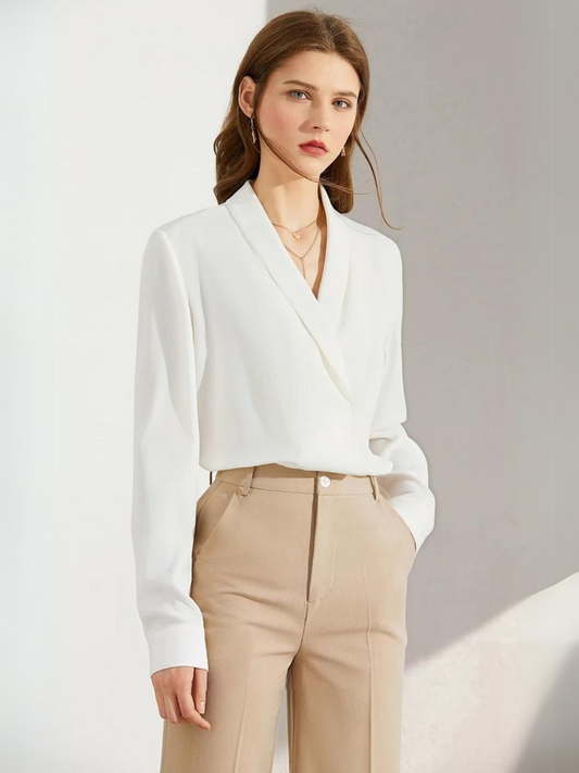 Woman wearing white blouse with V-neck and beige trousers