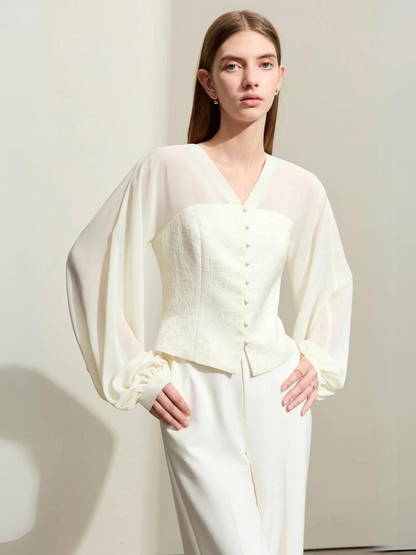 Front view of cream blouse with voluminous sleeves and fitted waist