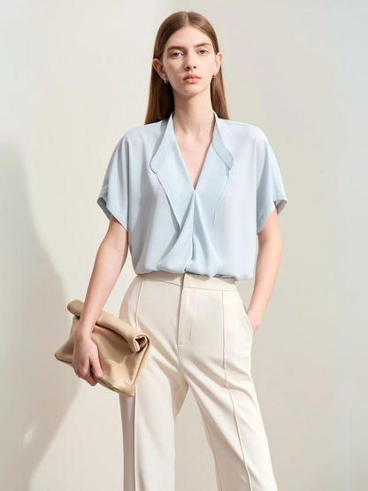 Front view of light blue short-sleeve blouse with pleated collar