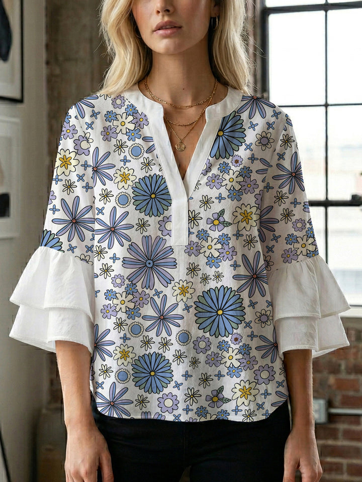 Damebluse med voluminøse ermer og blomsterdesign Skjora