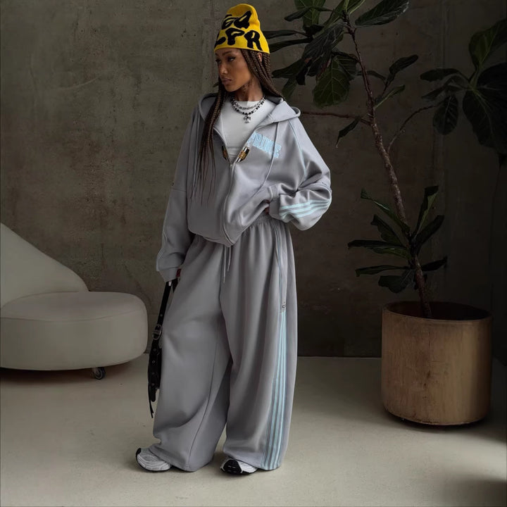 Kvinnesporty fritidssett med løst skjært hettegenser og løse bukser Skjora