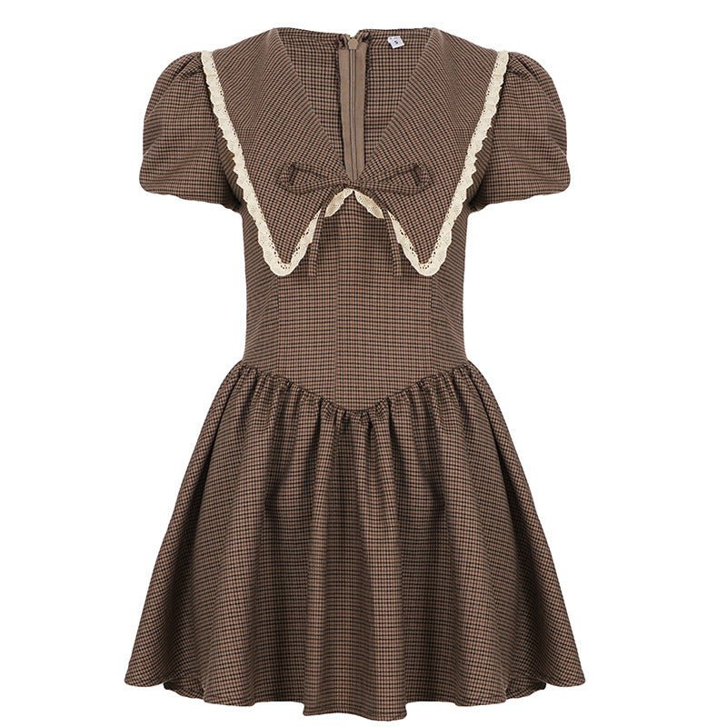 Ladies' dress with elegant collar and ruffle details Skjora