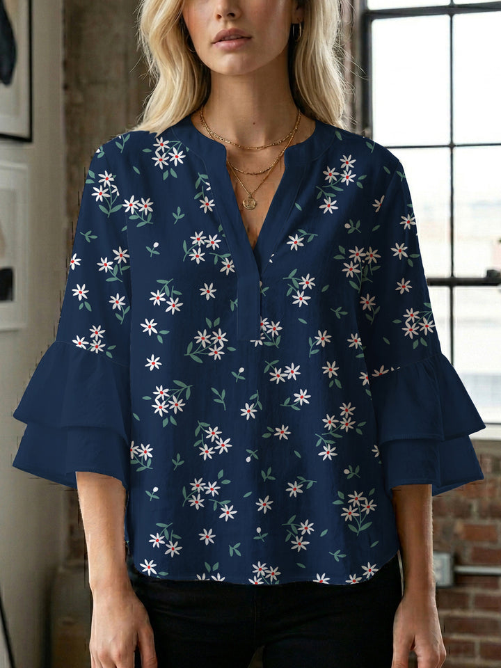 Damebluse med voluminøse ermer og blomsterdesign Skjora