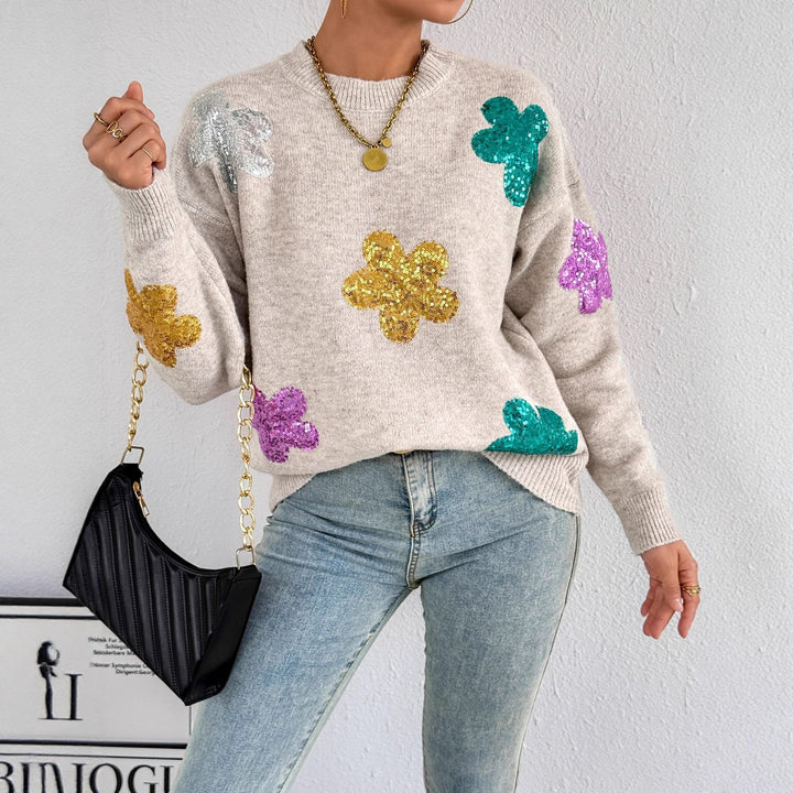 Kvinnes glitrende oversized genser med blomstermotiv Skjora