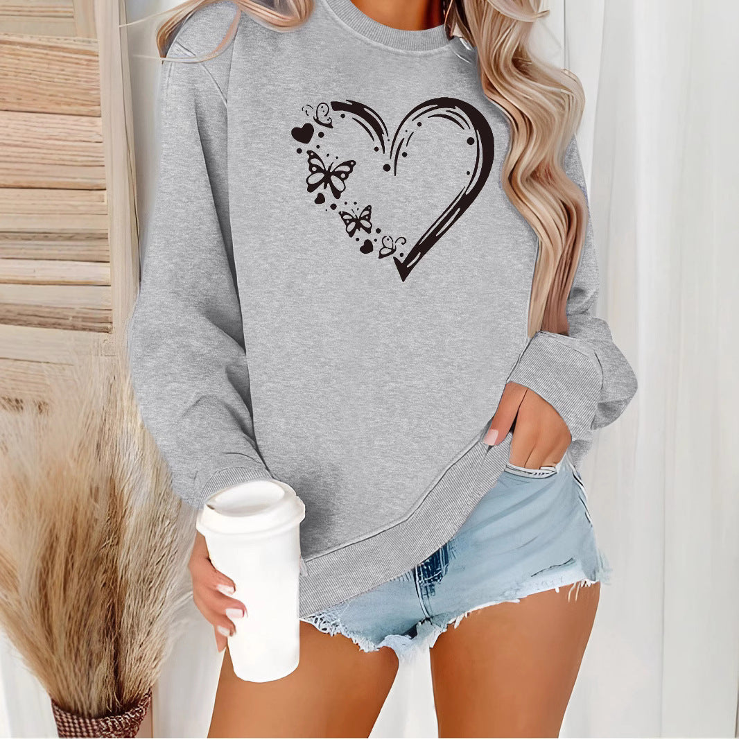 Dame sweatshirt med kreativt hjerte- og sommerfugl-design Skjora