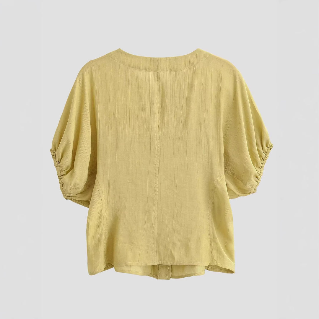 Damebluse med pufferm og dekorative knapper Skjora