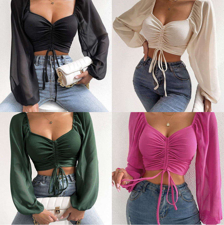 Dame Crop-Top med strukturert kropp og elegante pufferm. Skjora