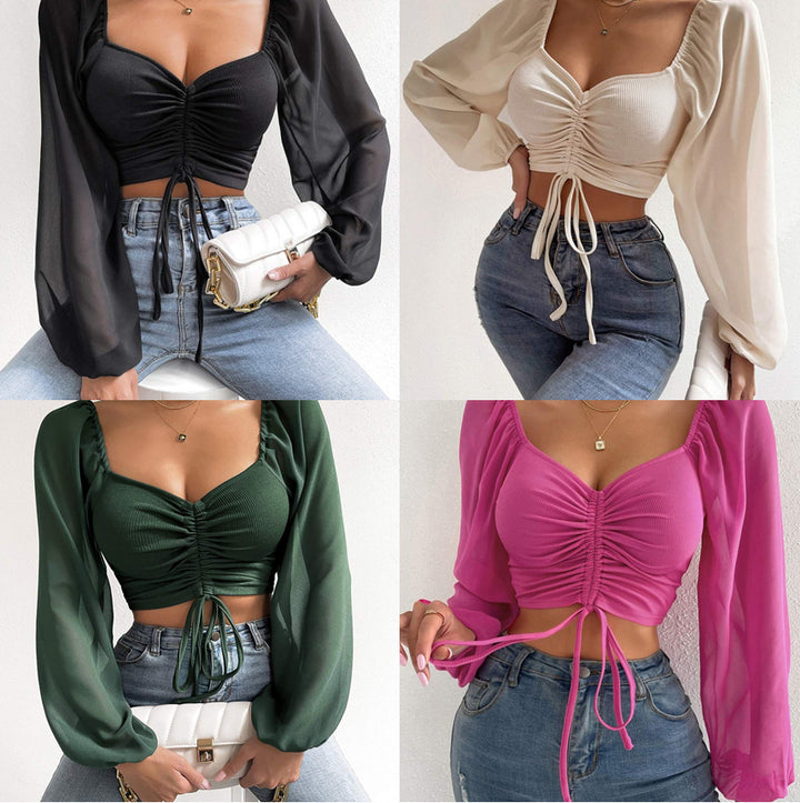 Dame Crop-Top med strukturert kropp og elegante pufferm. Skjora