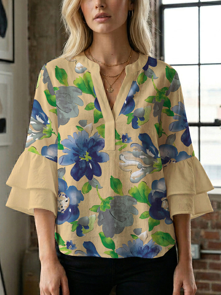Damebluse med voluminøse ermer og blomsterdesign Skjora