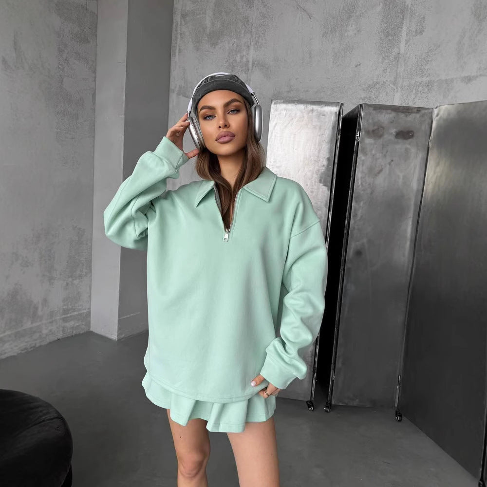 Kvinnors sportiga oversized pullover med kort dragkedja och ribbade avslut Skjora