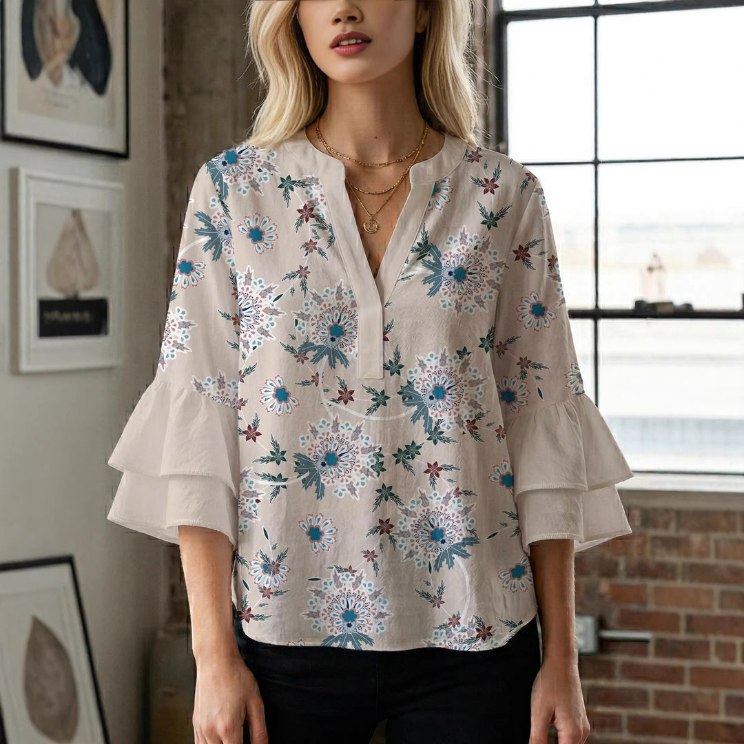 Damebluse med voluminøse ermer og blomsterdesign Skjora