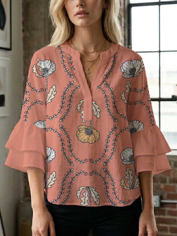 Damebluse med voluminøse puffermer og kreativt blomstermønster Skjora