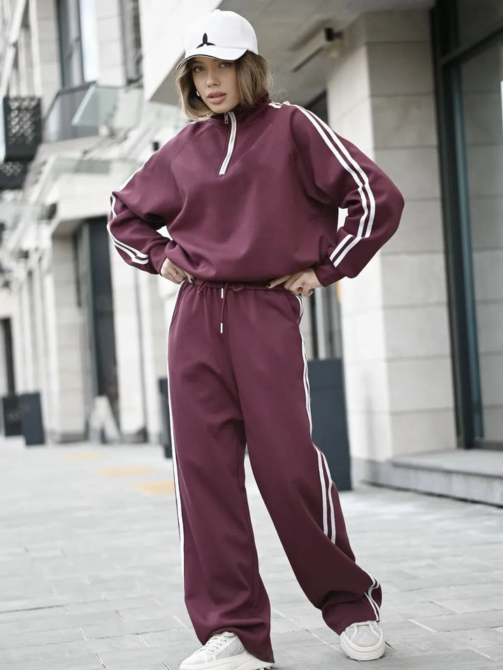 Kvinnelig sporty treningsdress med glidelås og striper Skjora