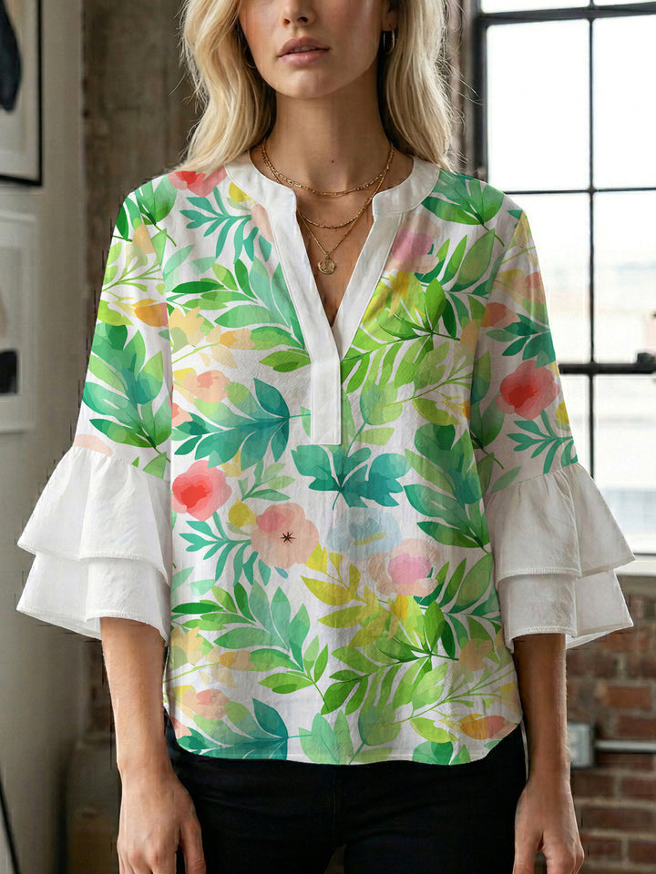 Damebluse med voluminøse ermer og blomsterdesign Skjora