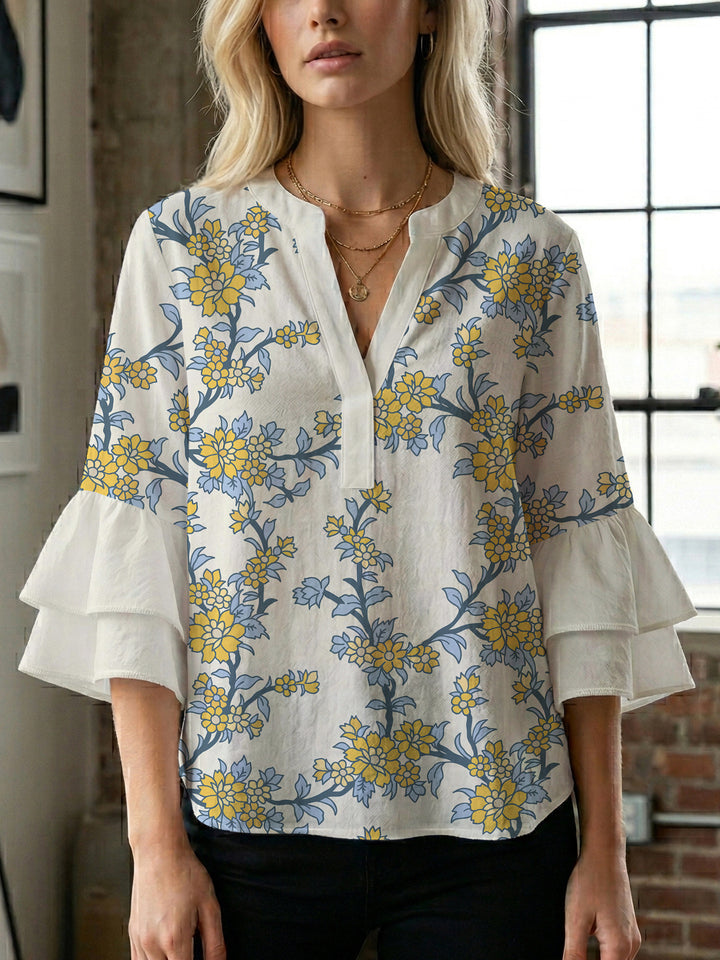 Damebluse med voluminøse ermer og blomsterdesign Skjora