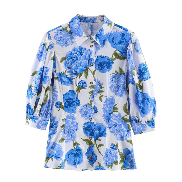 Damebluse med blomsterdesign og elegante puffermedeer Skjora