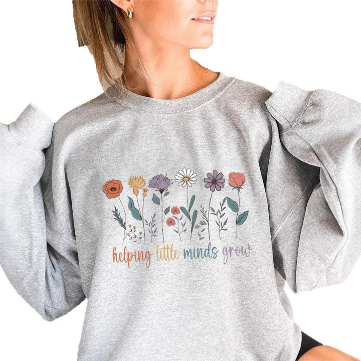 Kvinnesweatshirt med voluminøse ermer og motiverende blomstertrykk Skjora