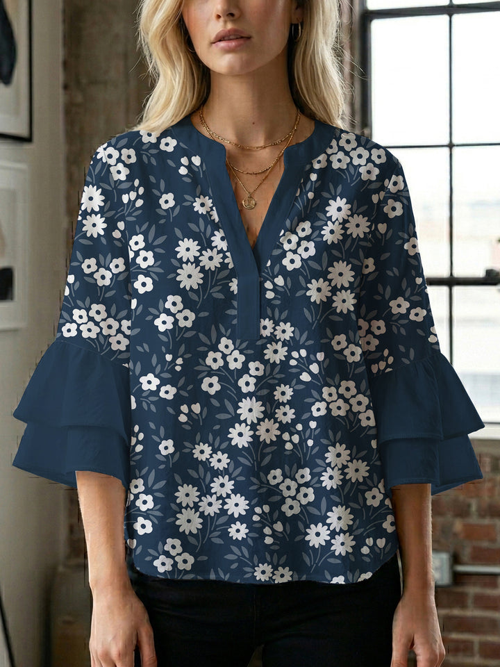 Damebluse med voluminøse ermer og blomsterdesign Skjora