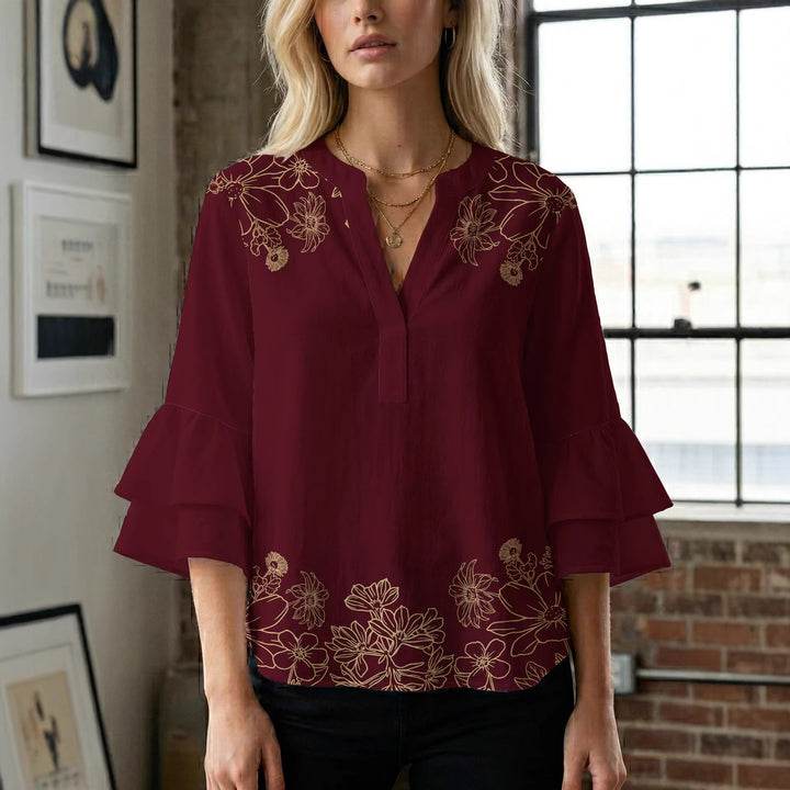 Damebluse med voluminøse volangermer og floral trykk Skjora