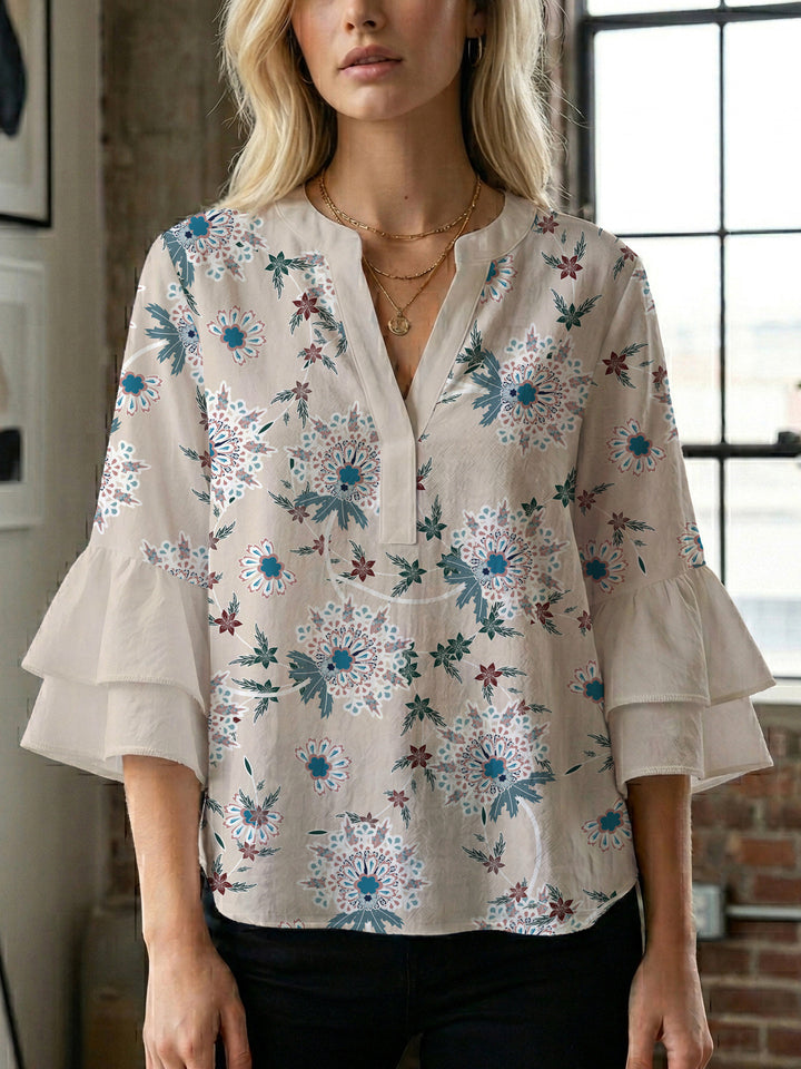 Damebluse med voluminøse ermer og blomsterdesign Skjora
