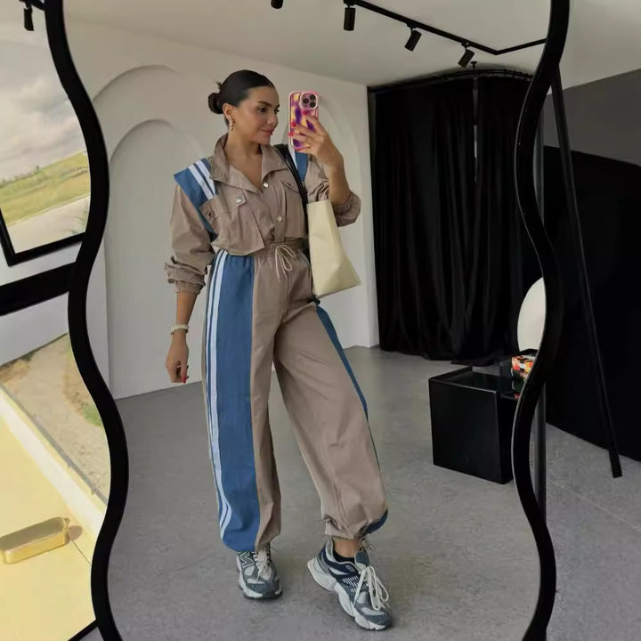Women's sporty jumpsuit with sophisticated drawstring detail at the waist and contrasting stripes on the skirt