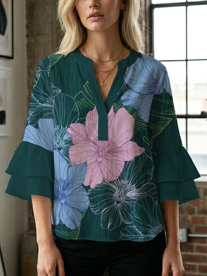 Damebluse med voluminøse ermer og blomsterdesign Skjora
