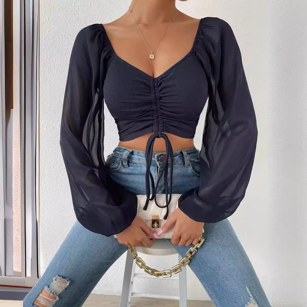 Dame Crop-Top med strukturert kropp og elegante pufferm. Skjora