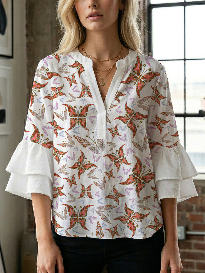 Damebluse med voluminøse puffermer og kreativt blomstermønster Skjora