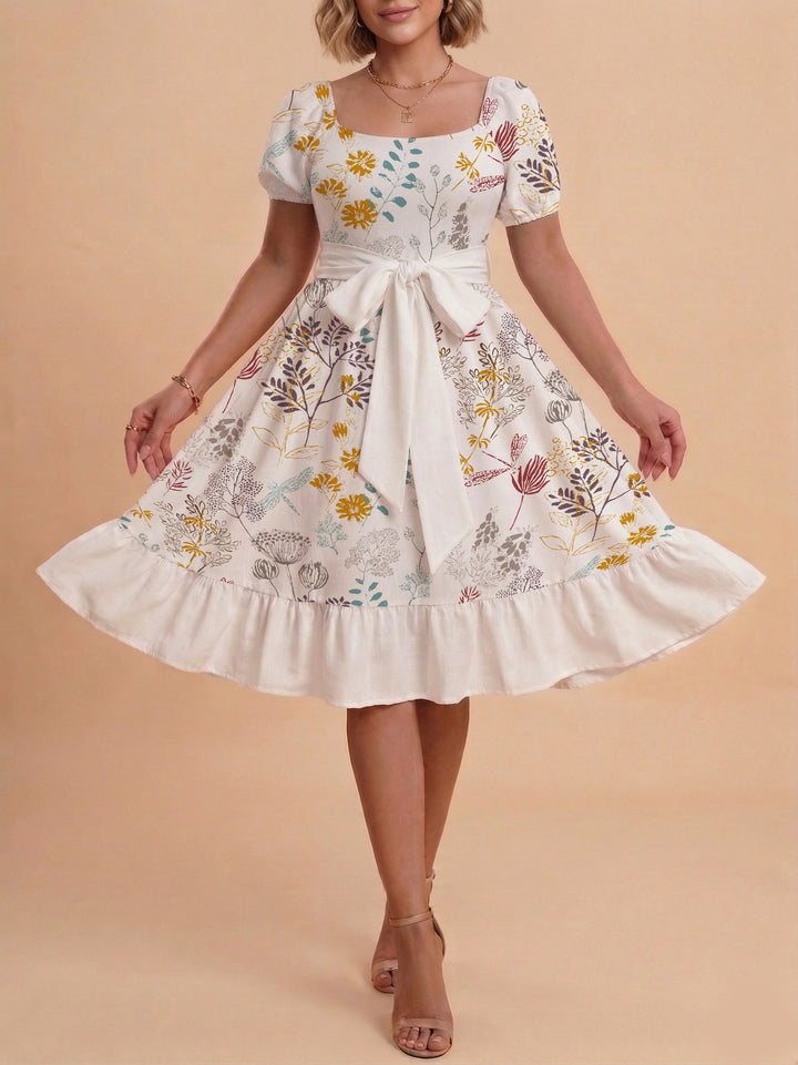 Damen modernes Blumenkleid mit elegantem Taillengürtel und asymmetrischem Saum Skjora