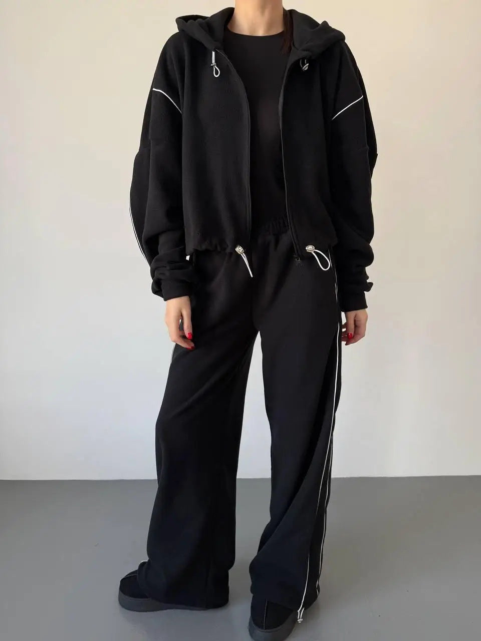 Kvinnenes avslappede hettegensers joggedrakt med løse bukser og side stripe Skjora