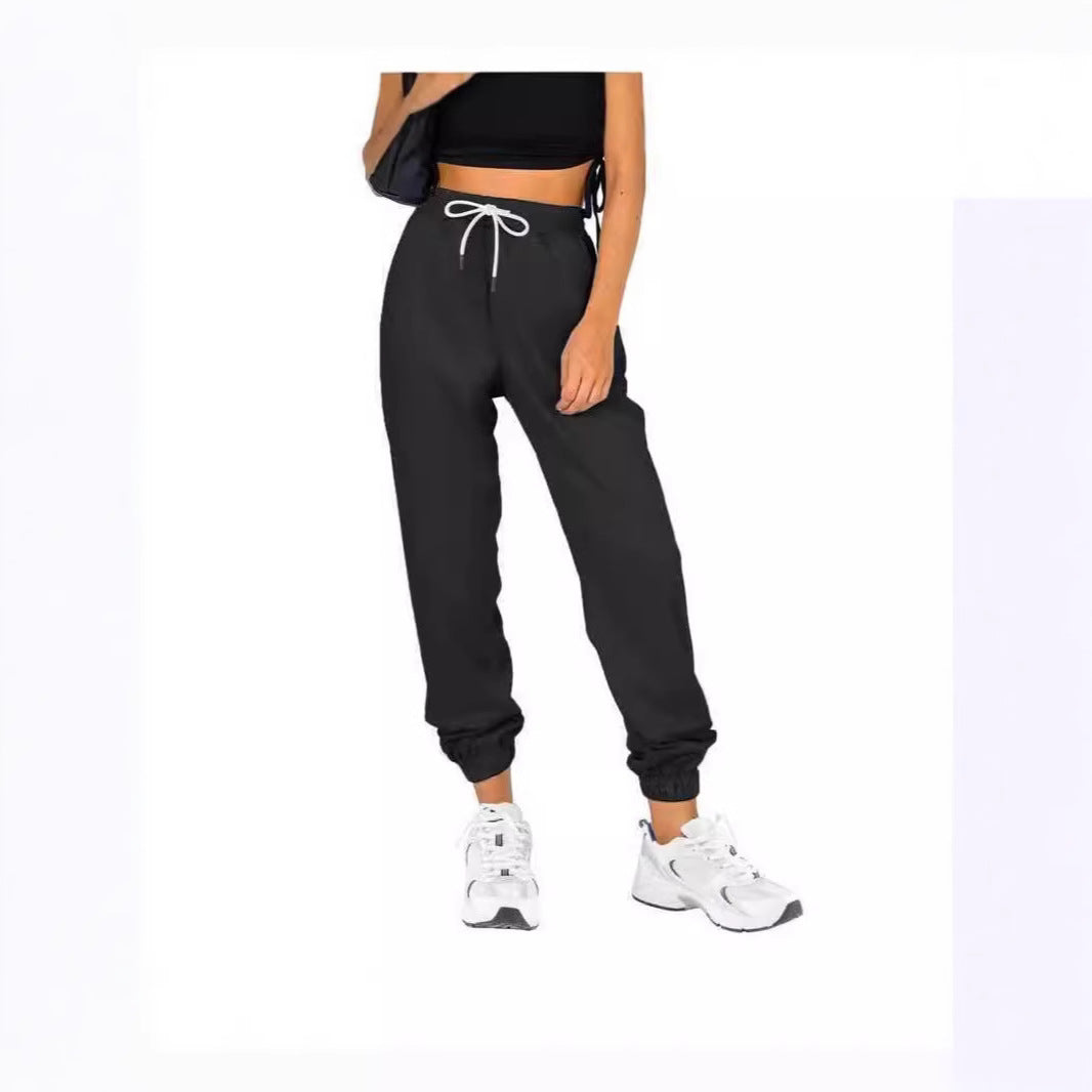 Kvinne sporty joggebukser med praktisk snor og elastisk liv.