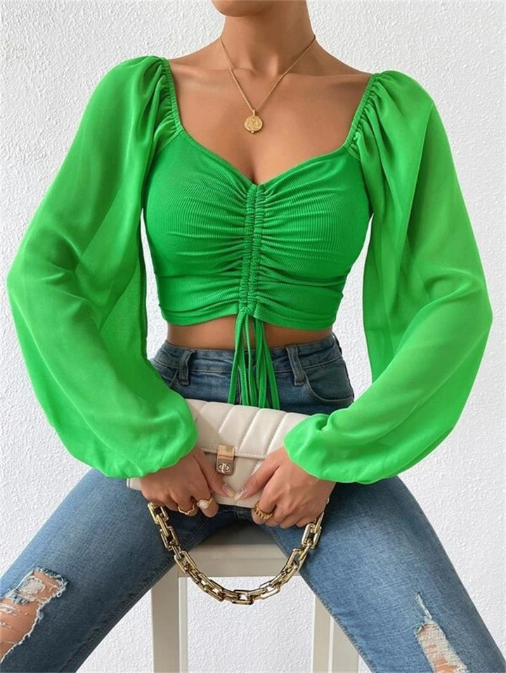 Dame Crop-Top med strukturert kropp og elegante pufferm. Skjora