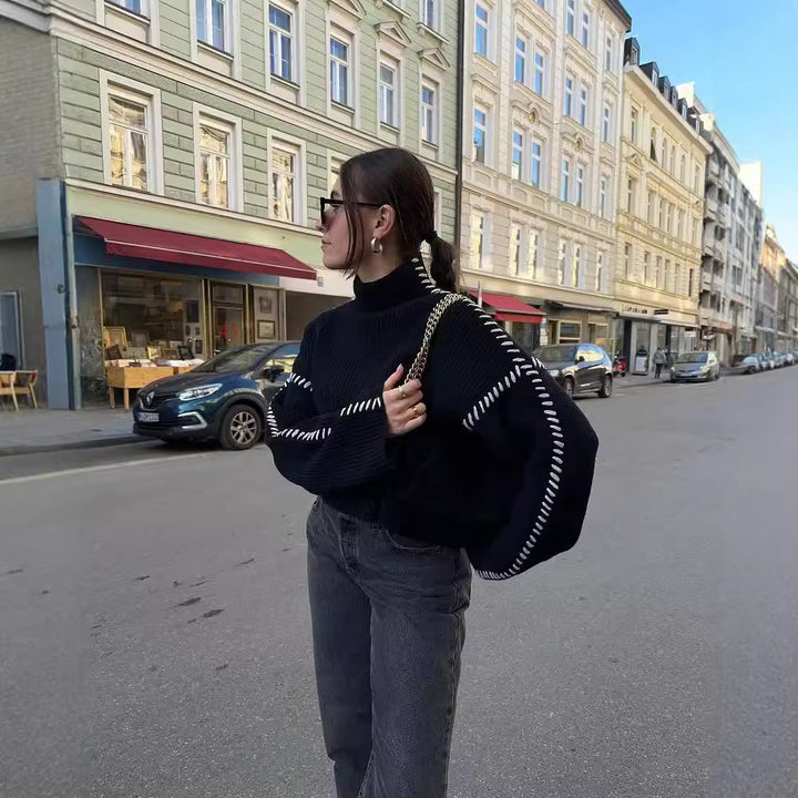 Kvinne chunky strikkegenser med høy krage og elegante erme detaljer Skjora