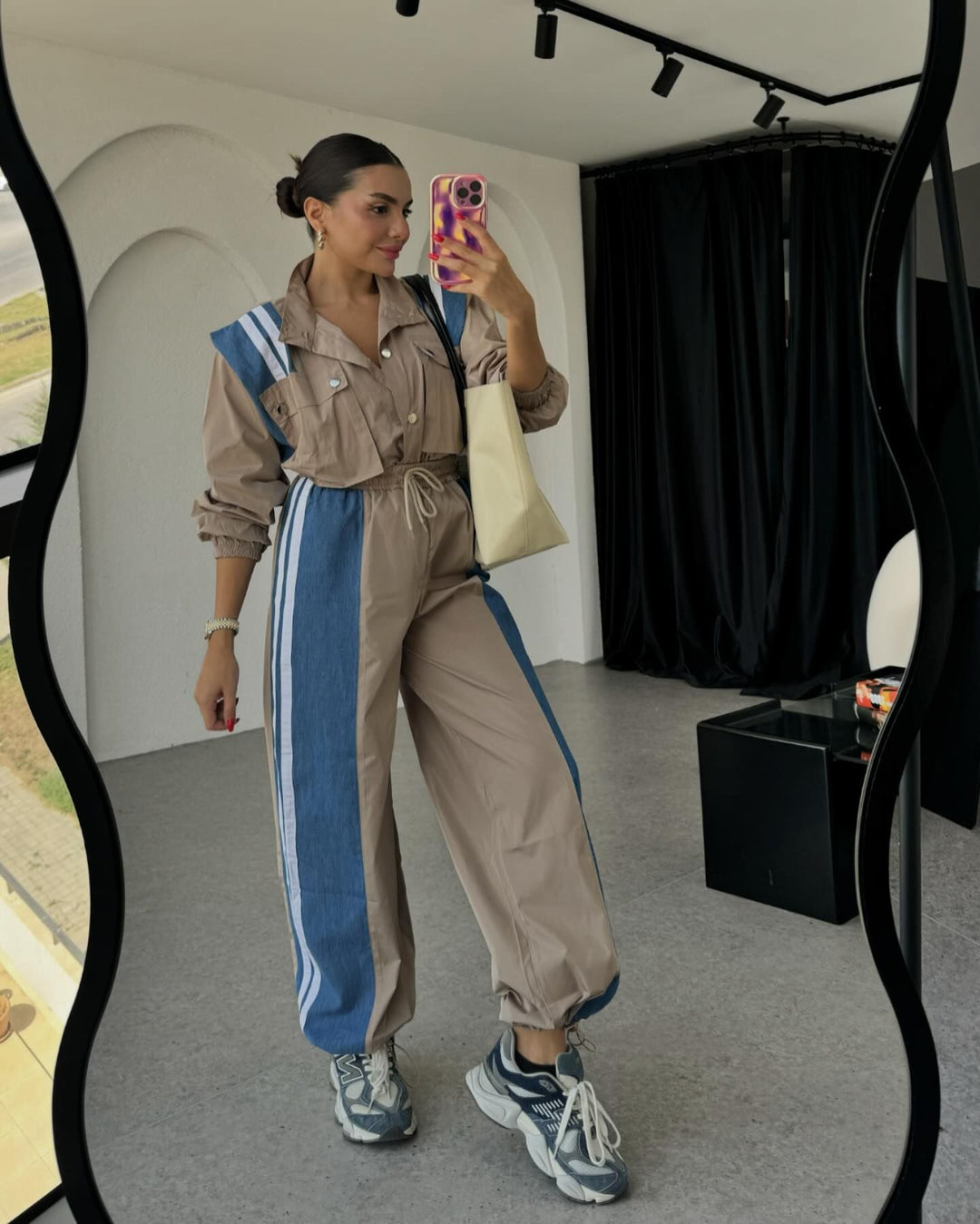 Women's sporty jumpsuit with sophisticated drawstring detail at the waist and contrasting stripes on the skirt