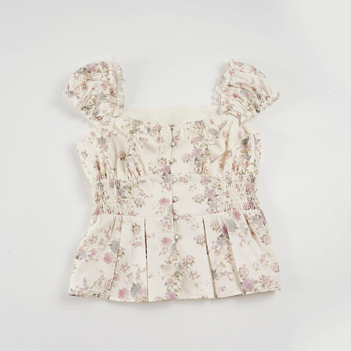 Damebluse med blomsterdesign og volanger
