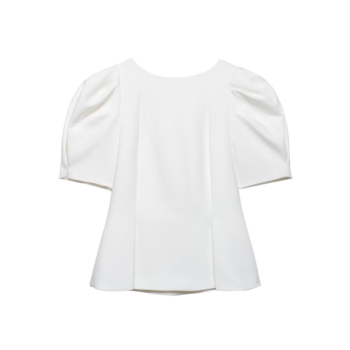 Damebluse med puffarmer og elegant snitt Skjora