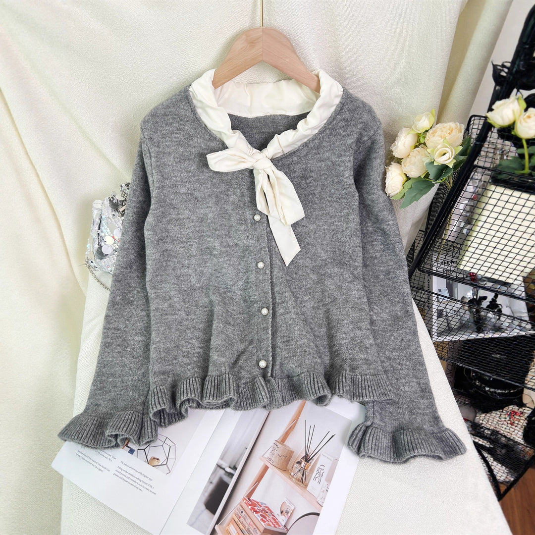 Kvinnes elegant cardigan med volanger og sløyfekrage Skjora