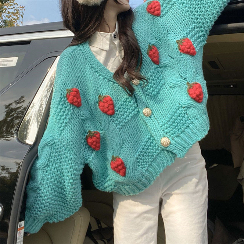 Kvinnest chunky strikk cardigan med nydelige blomsterapplikasjoner og gullknapper Skjora