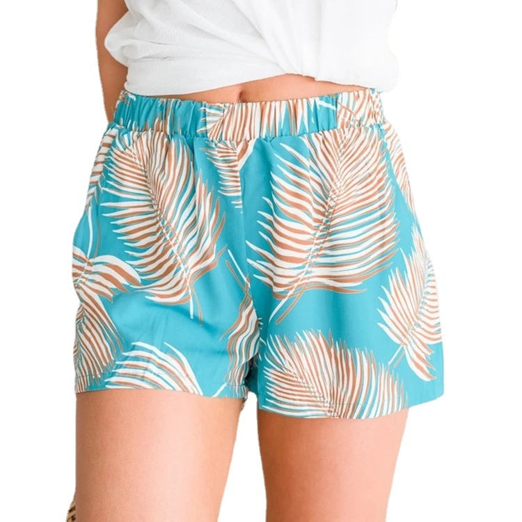 Kvinnens luftige strandshorts med elastisk midje og tropisk bladdesign
