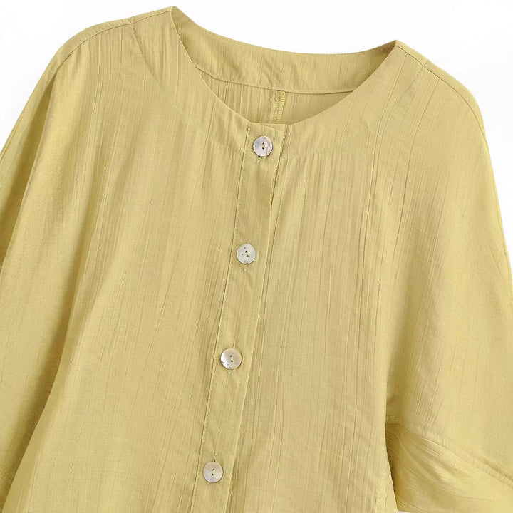 Damebluse med pufferm og dekorative knapper Skjora