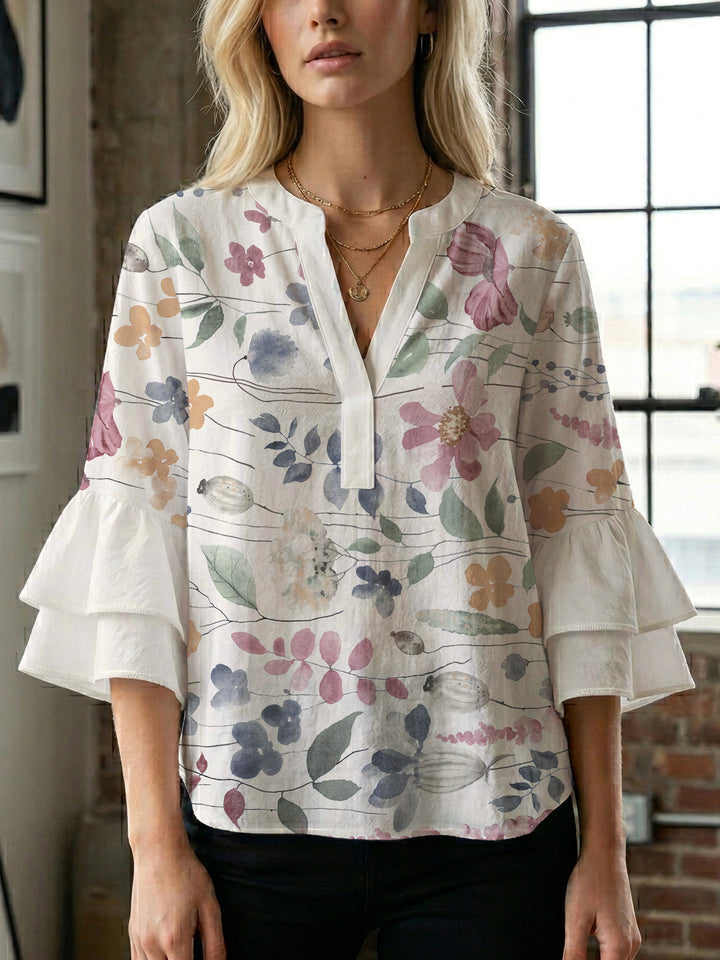 Damebluse med voluminøse ermer og blomsterdesign Skjora