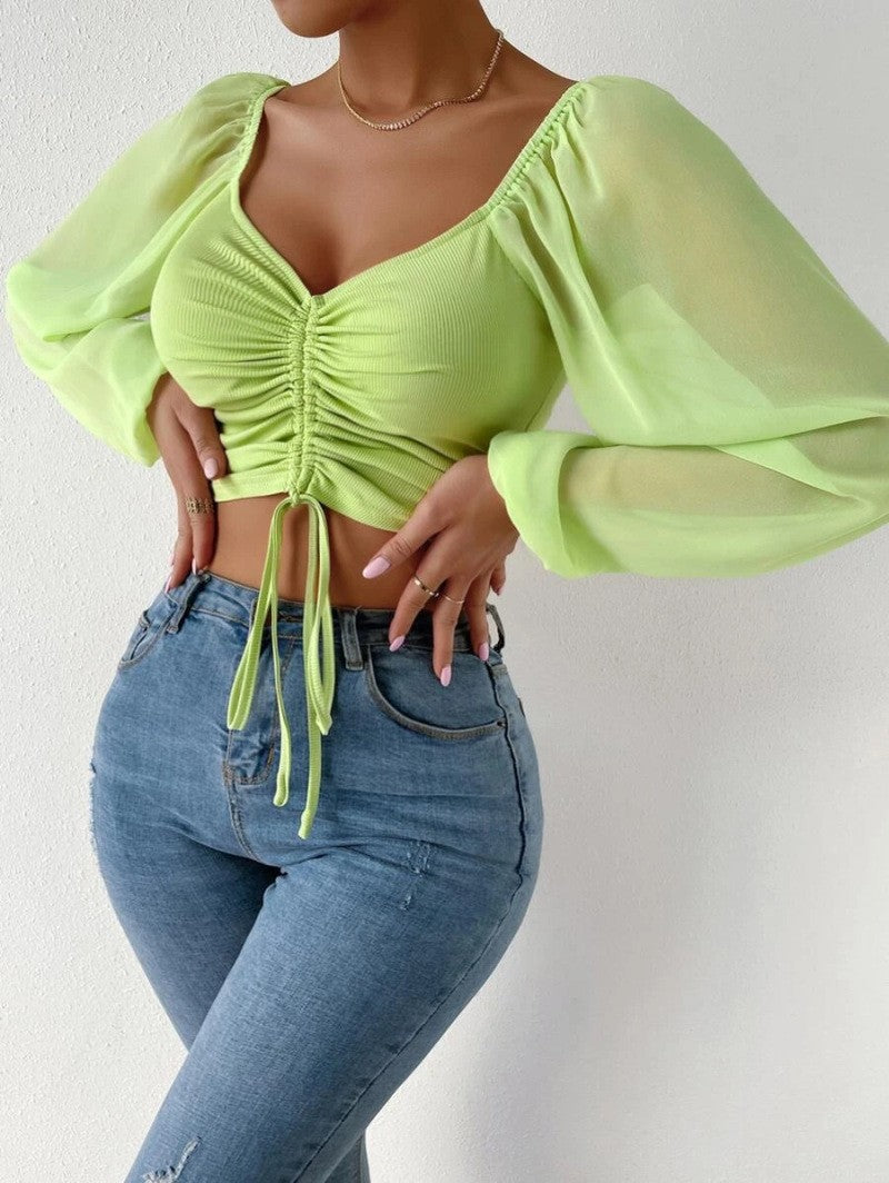 Dame Crop-Top med strukturert kropp og elegante pufferm. Skjora