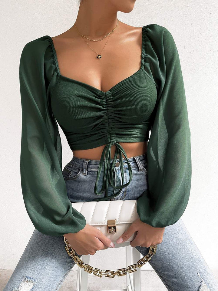 Dame Crop-Top med strukturert kropp og elegante pufferm. Skjora