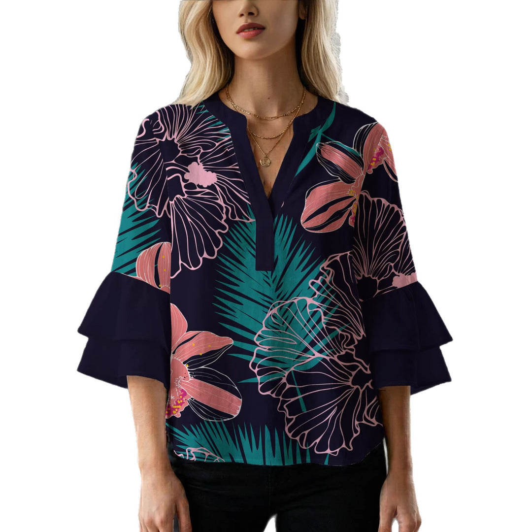 Damebluse med voluminøse volangermer og floral trykk Skjora