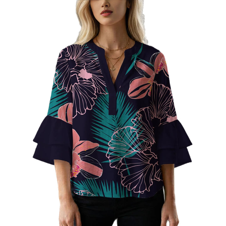 Damebluse med voluminøse volangermer og floral trykk Skjora