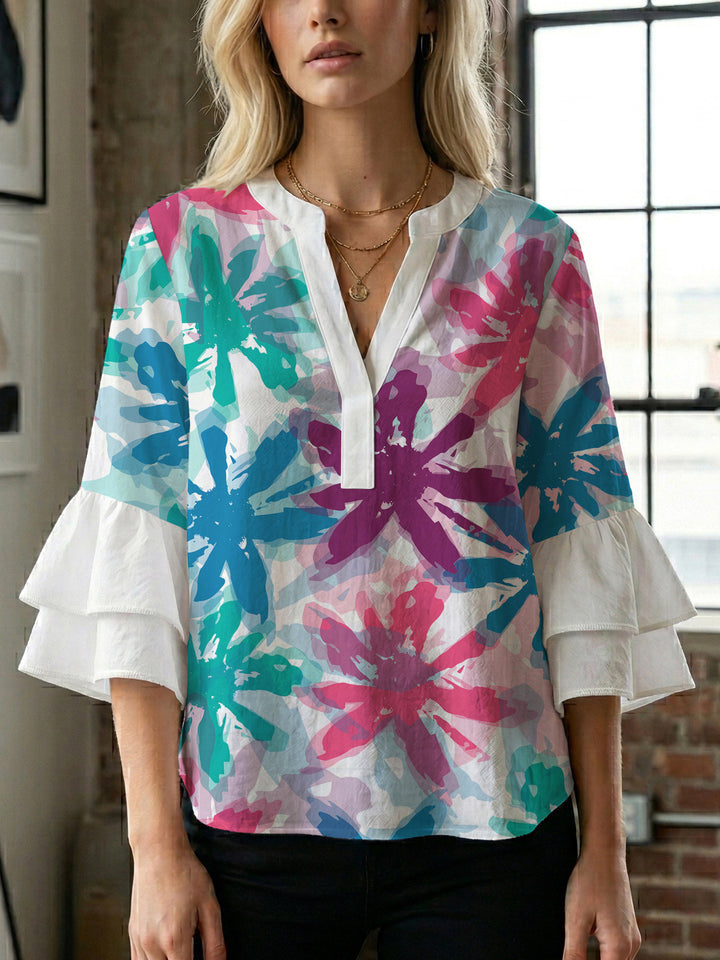 Damebluse med voluminøse ermer og blomsterdesign Skjora